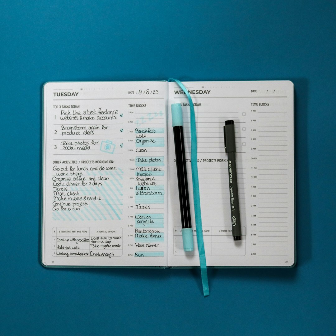 Close-up of printed statistical charts, pen and notebook on a desk