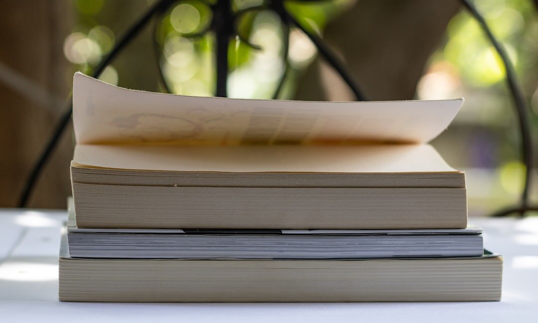 Stack of printed research reports and bound studies on a table